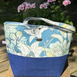 Load image into Gallery viewer, Fleur tote bag front with floral print and blue base.