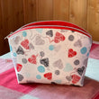 Load image into Gallery viewer, Handcrafted zipper travel pouch by Joeriaknits with heart and yarn pattern