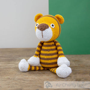 Crocheted tiger toy with yellow and brown stripes.