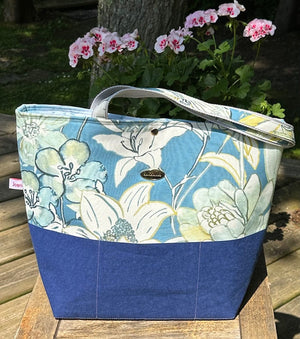 Fleur tote bag front with floral print and blue base.