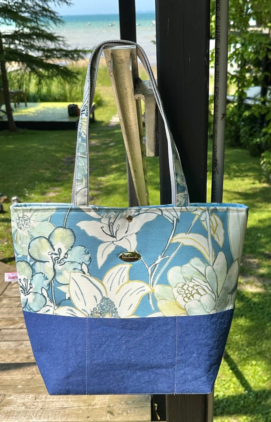 Fleur tote bag hanging with blue floral design
