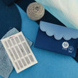 Load image into Gallery viewer, KnitPro Nova Double Pointed Needle Deluxe Set displayed with knitting accessories on a blue background.
