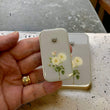 Load image into Gallery viewer, Notions Tin by Firefly Notes featuring rose and bee design, held in hand, perfect for organizing knitting supplies.
