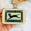 Load image into Gallery viewer, Notions Tin by Firefly Notes featuring black cat illustration on vintage style matchbox.
