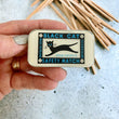 Load image into Gallery viewer, Notions Tin by Firefly Notes featuring a black cat design and vintage matchbox illustration, perfect for organizing small supplies.
