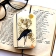 Load image into Gallery viewer, Notions Tin by Firefly Notes featuring a vintage crow design atop a book, perfect for organizing shiny things.
