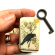Load image into Gallery viewer, Notions Tin by Firefly Notes featuring a vintage crow design and the words 'SHINY THINGS', held in hand.
