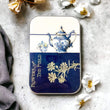 Load image into Gallery viewer, Notions Tin Firefly Notes featuring a blue teapot and floral design, perfect for organizing craft supplies.
