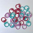 Load image into Gallery viewer, Spiral Stitch Markers in red, teal, mauve, yellow, green, and orange – Set of 30 for knitting and crochet projects.
