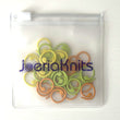 Load image into Gallery viewer, Spiral Stitch Markers — Set of 30 in yellow, green, and orange, packaged in a clear resealable bag.
