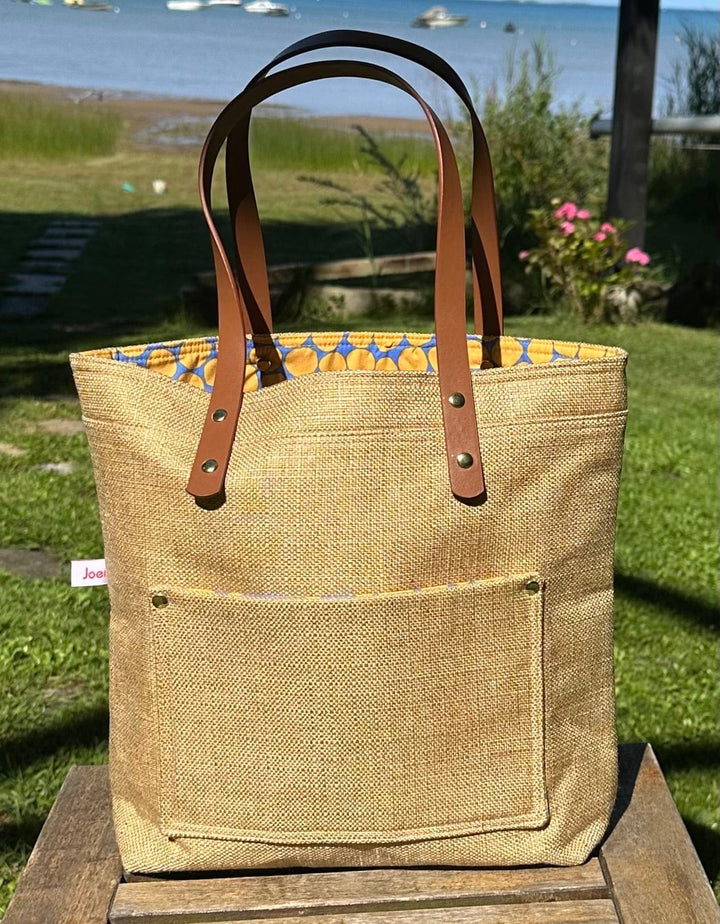 Project Bags for Knitters and Crocheters made from up-cycled upholstery fabric with faux leather handles and exterior pocket.